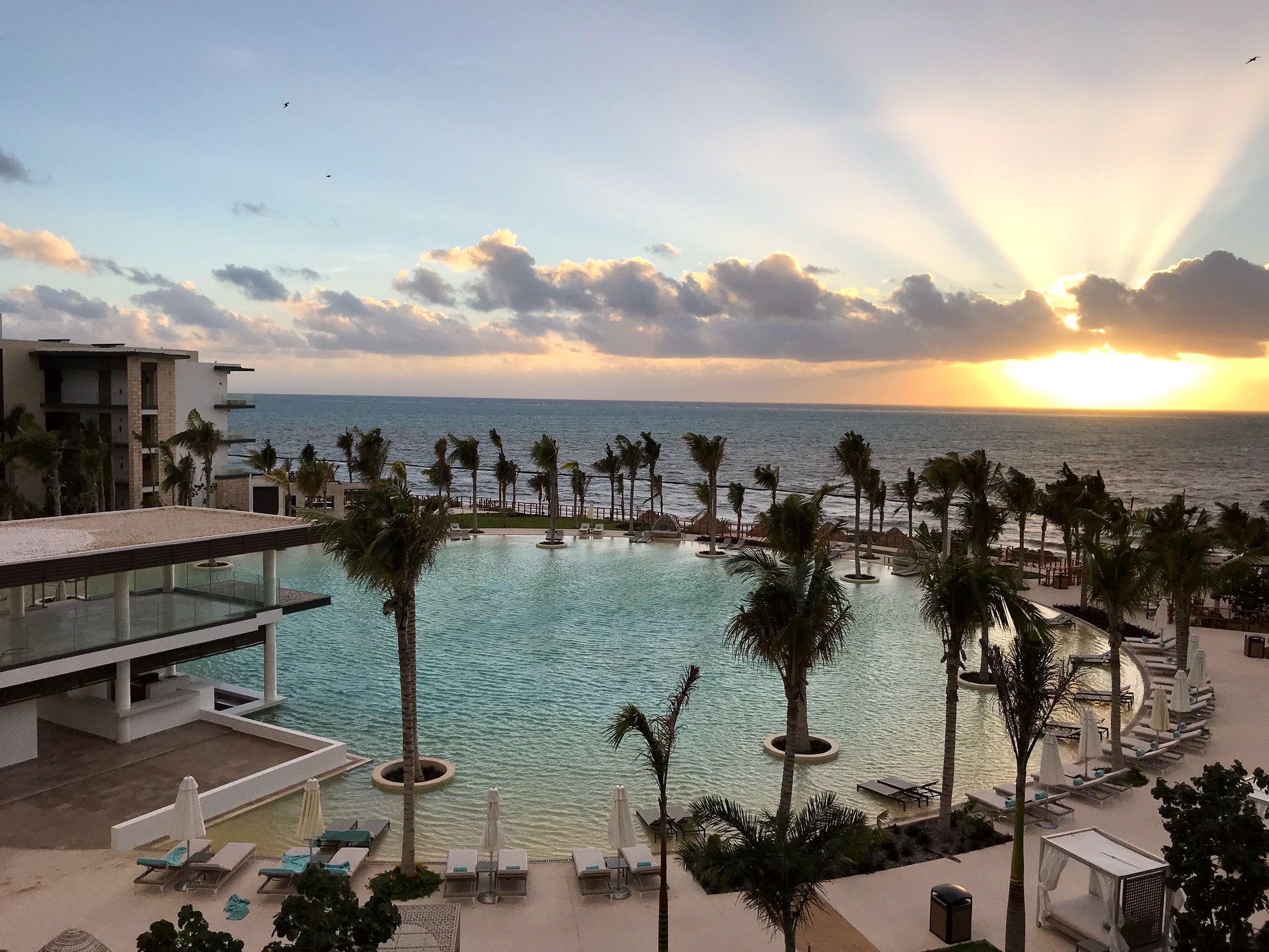 Sunrise over the ocean from the resort pool deck in the Riviera Maya